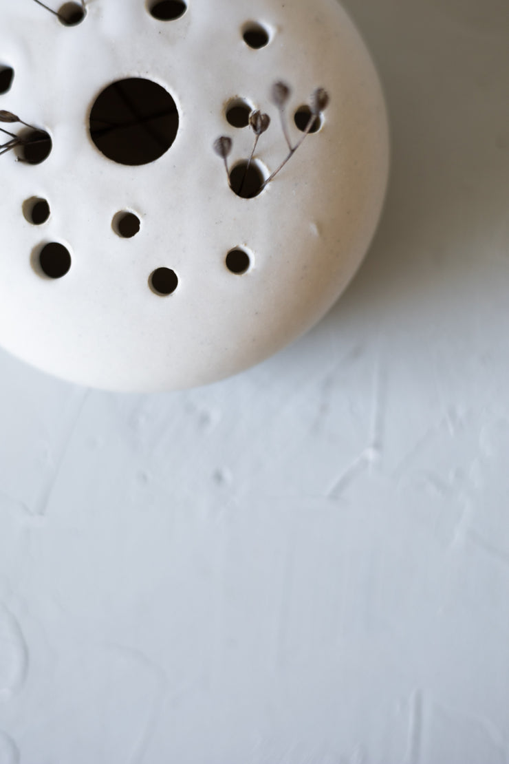 A handthrown and unique ceramic flower frog to dress up your table